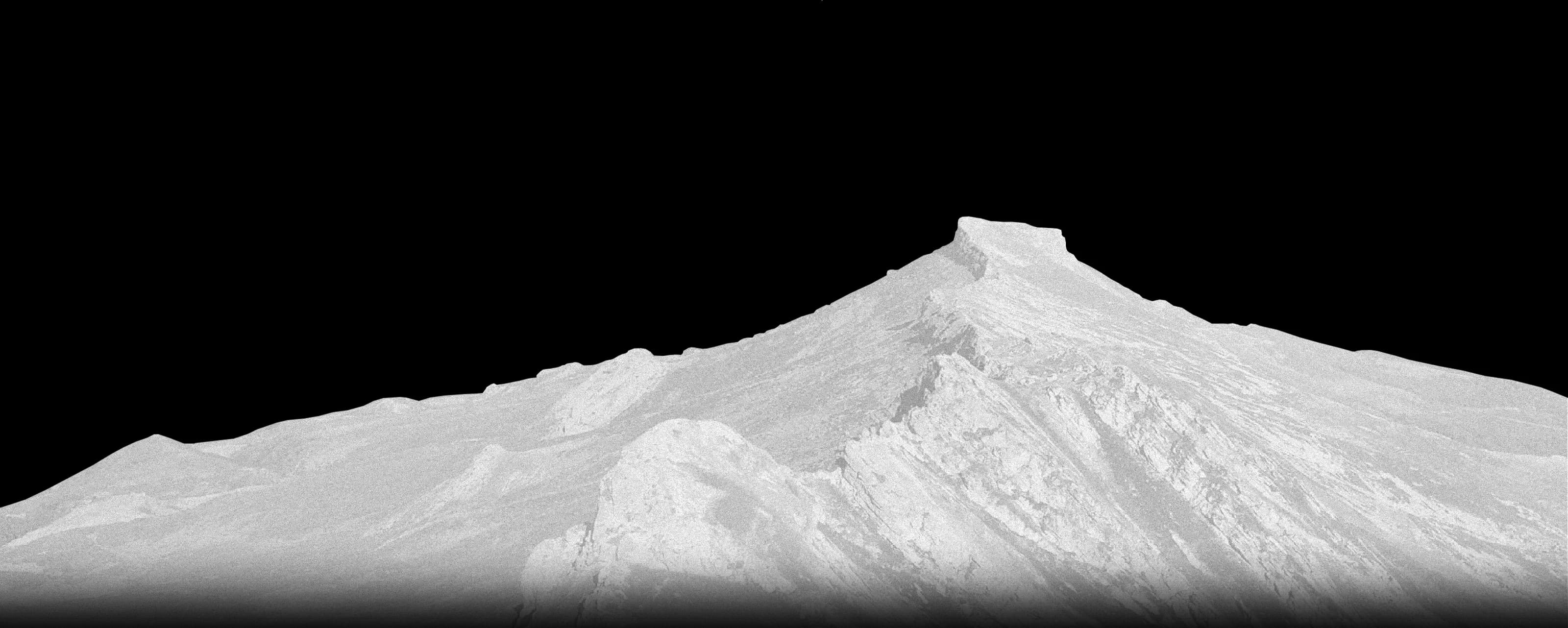 Grayscale mountain ridge under haze